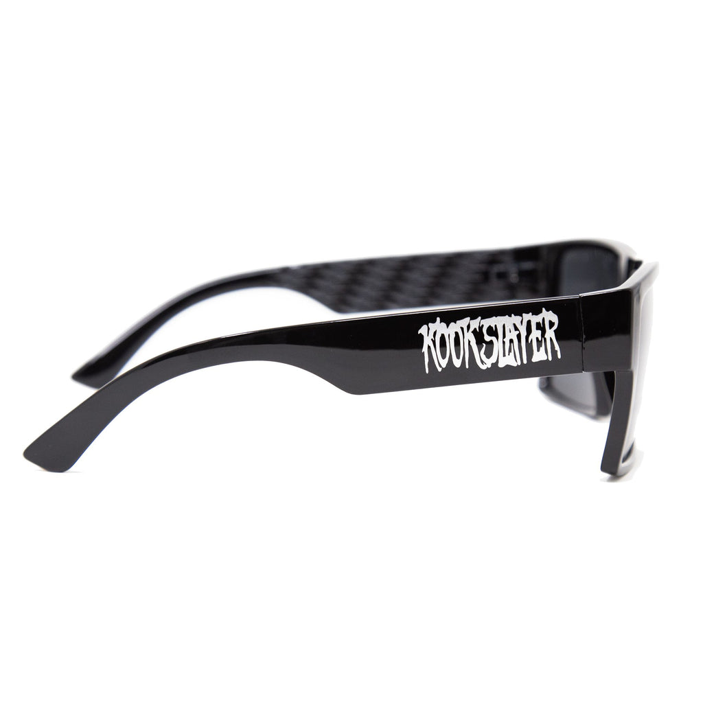 Kookslayer sunglasses with Kookslayer lettering on the arm and checkered inner arms — angled