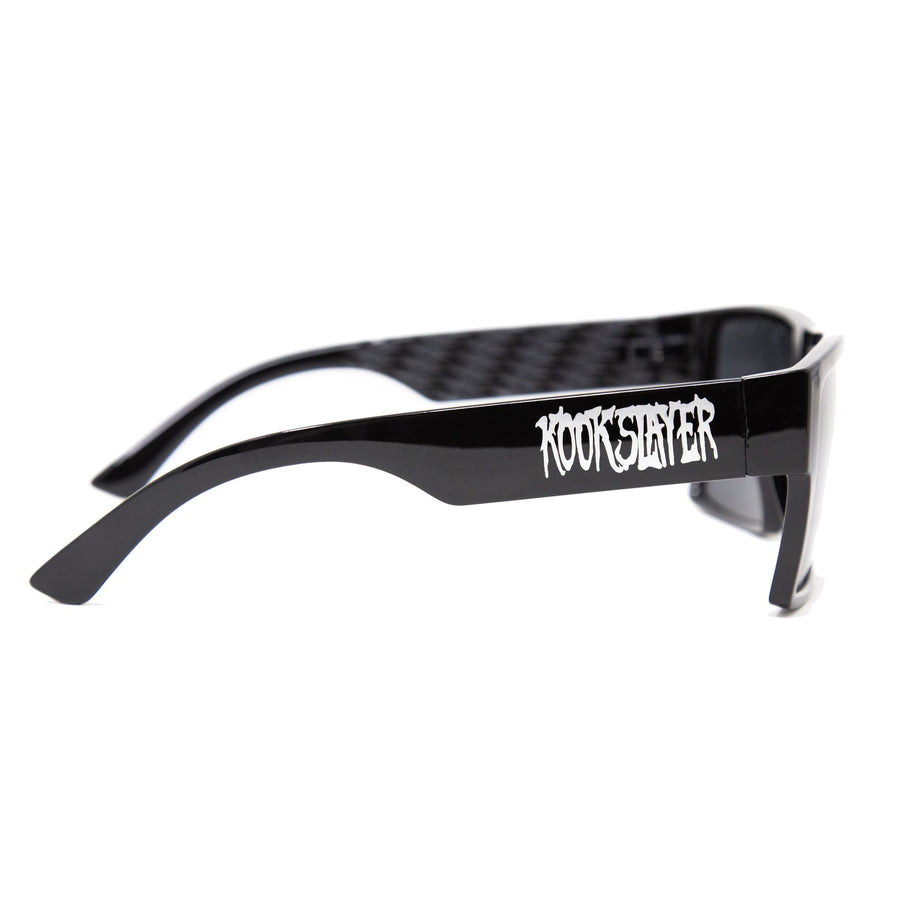 Kookslayer sunglasses with Kookslayer lettering on the arm and checkered inner arms — angled